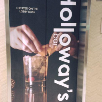 Elevator wrap for Holloways bar with a drink being garnished