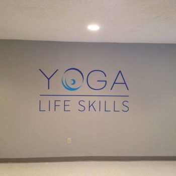 Wall graphic promoting Yoga Life Skills organization