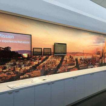 Digital sign that fits perfectly into wall mural of city