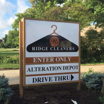 Directional sign pointing readers toward Ridge Cleaners' drive-through