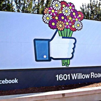 Outdoor sign of Facebook hand holding flowers