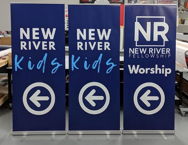 Three pop up banners promoting New River Worship