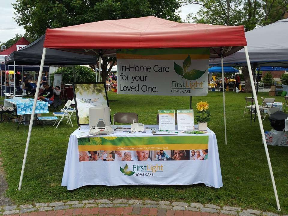 Event tent and printed fabric promoting FirstLight Home Care at an outdoor trade show
