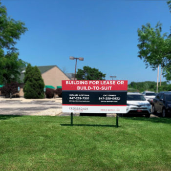 Real estate sign promoting building for lease