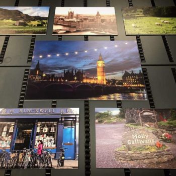 Multiple travel photos displayed on a wall