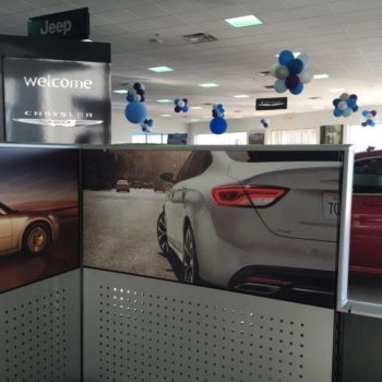 A tradeshow display of multiple cars at a dealership