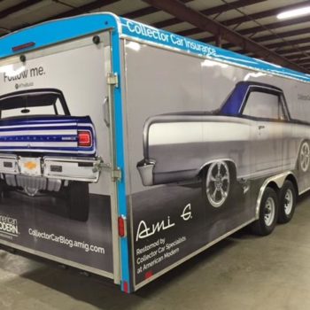 A vehicle wrap of a car on a trailer