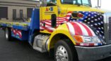 A vehicle wrap of an American flag on a tow truck
