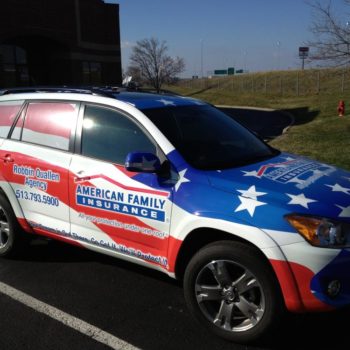 A side view of an american flag patterned vehicle wrap for American Family Insurance