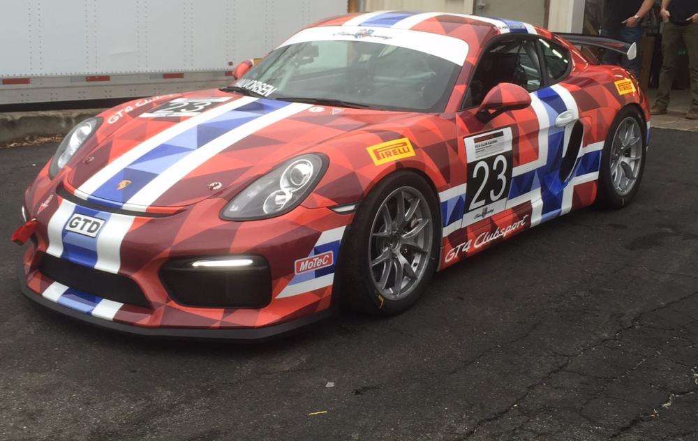 A red, blue and white vehicle wrap on a sports car
