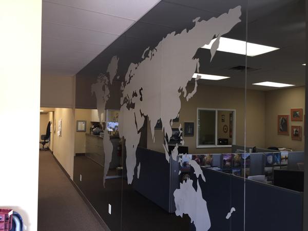 A window graphic of a worldmap in an office
