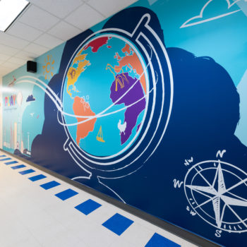 A large environmental graphic of globe and compass