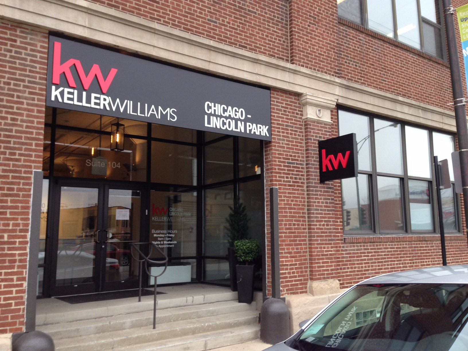 An outdoor sign and logo for Keller Williams 