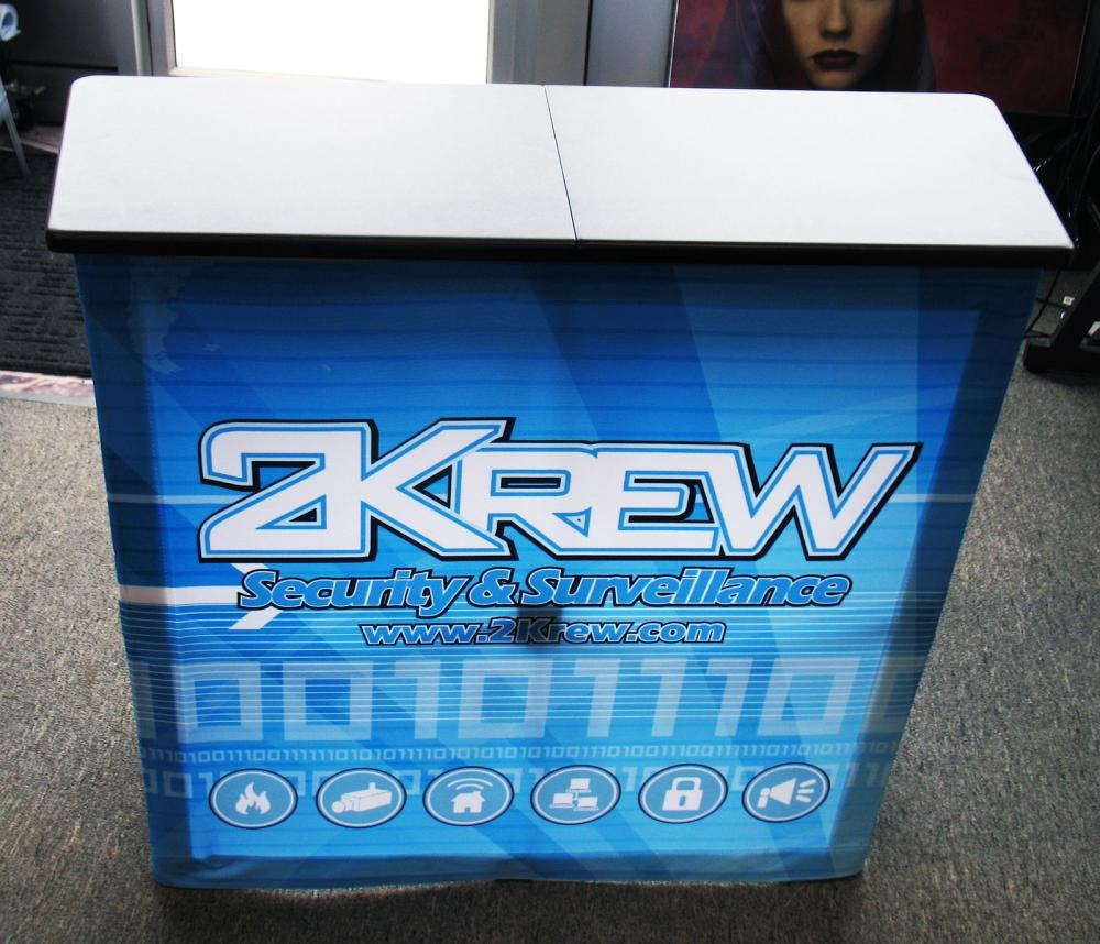 A printed fabric sign for 2krew on a podium
