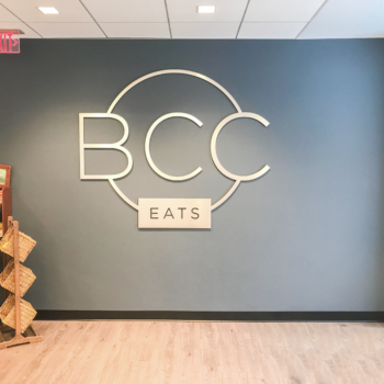 BCC eats logo signage on wall