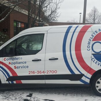 A partial wrap for an appliance service company, featuring red and blue curved stripes and their custom branding