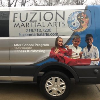 Side view of Fuzion Martial Arts van with custom wrap