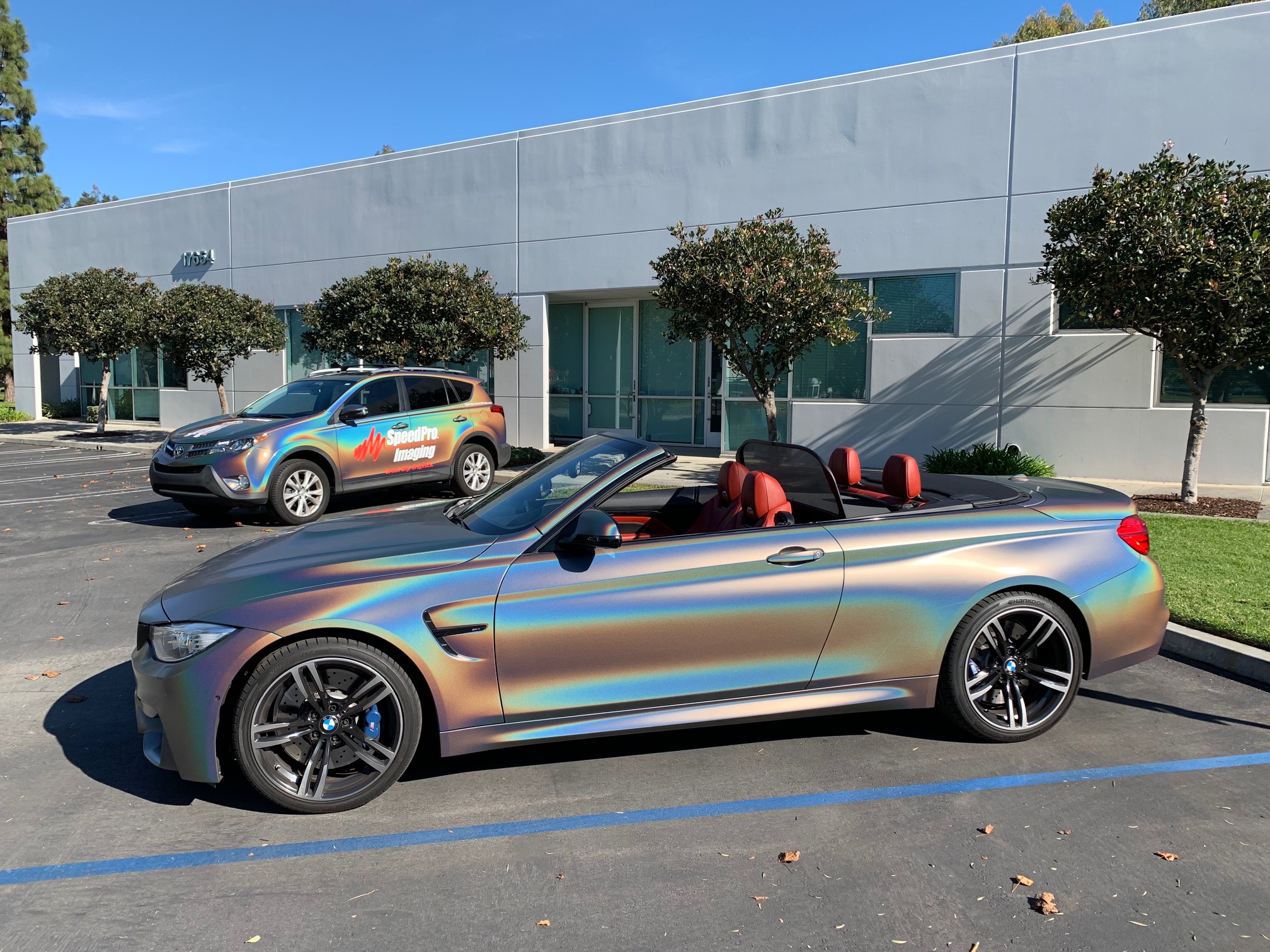 cars with holographic paint in a parking lot