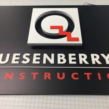 Quesenberry's Construction logo sign on wall