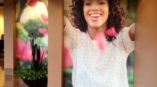 Wall mural with smiling woman throwing flower petals