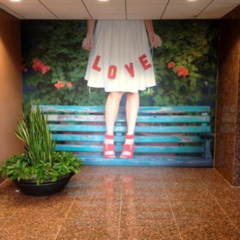 Indoor love wall mural with a girl standing on a bench