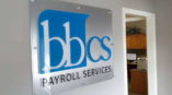 BBCS payroll services glass wall sign
