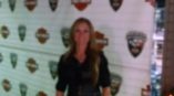 Woman in front of step and repeat banner