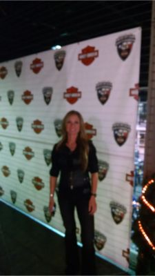 Woman in front of step and repeat banner