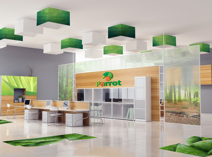Green and orange parrot logo on tan wall near desks with white screens. 