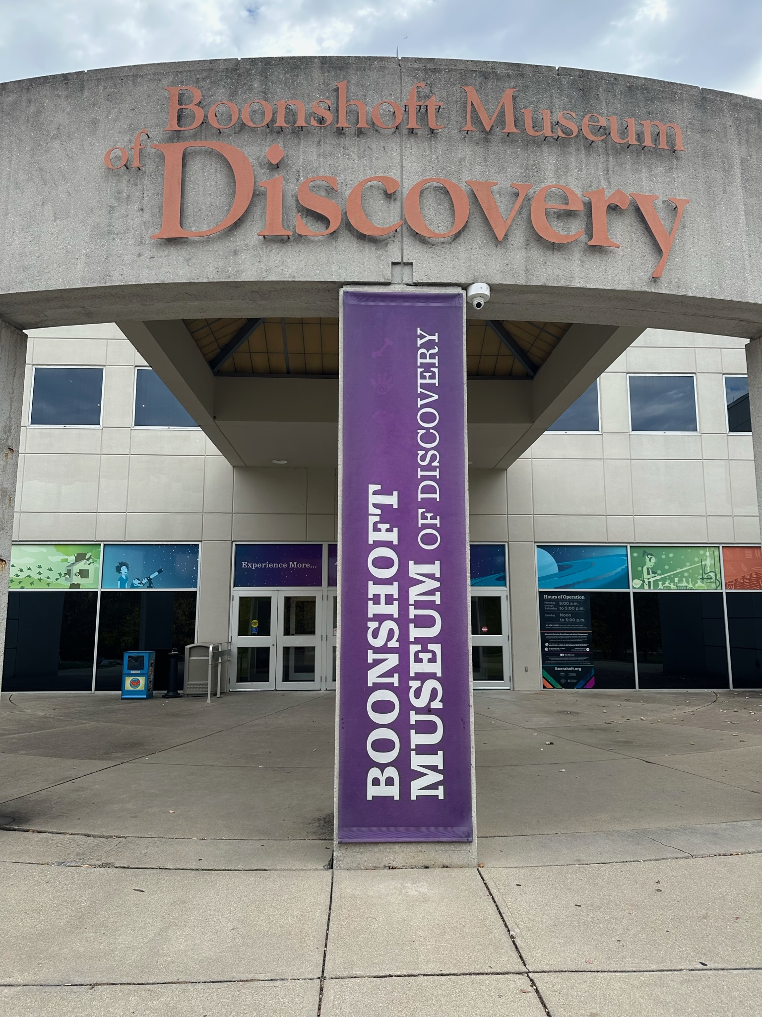 Concrete building sign with raised letters and a vertical fabric banner in Dayton, Ohio.