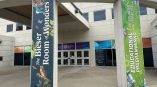 Two vertical fabric banners with printed graphics on concrete pillars in Dayton, Ohio.