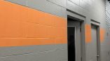 Painted wall stripes in gray and orange on a cinder block wall in Dayton, Ohio.