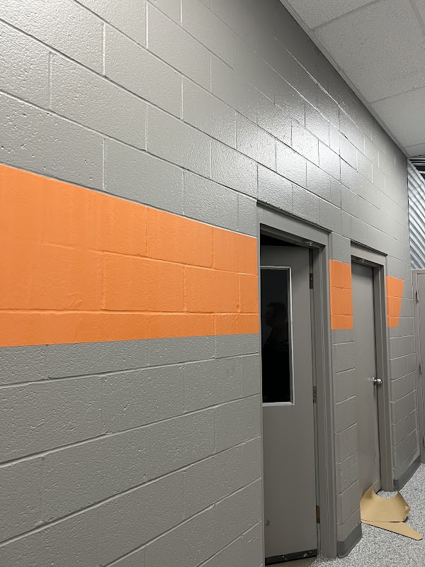 Painted wall stripes in gray and orange on a cinder block wall in Dayton, Ohio.