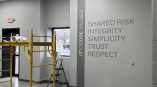 Vinyl wall graphics with text and vertical stripe in a commercial space in Dayton, Ohio.