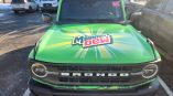 Green commercial vehicle hood wrap with graphic design on a Ford Bronco in Dayton, Ohio.