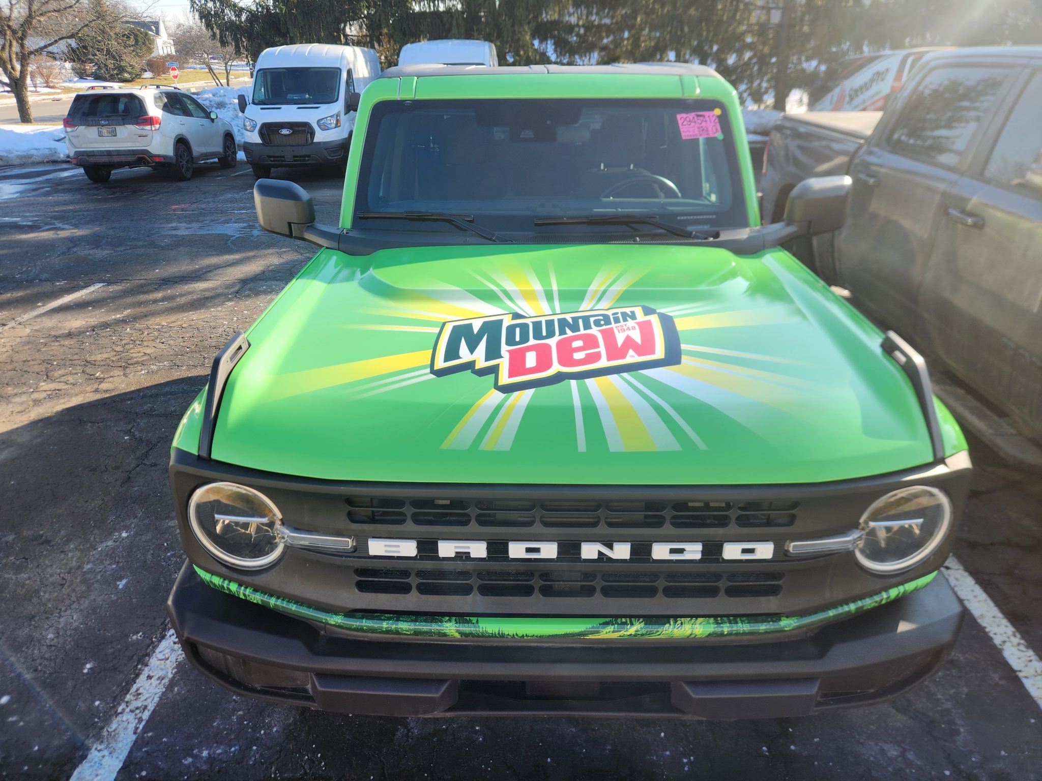 Green commercial vehicle hood wrap with graphic design on a Ford Bronco in Dayton, Ohio.