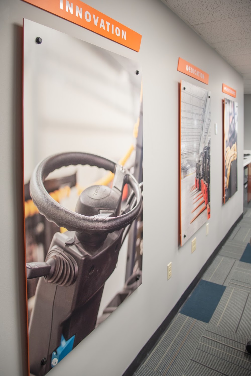 Three large acrylic office signs with industrial images and orange headers in Dayton, Ohio.