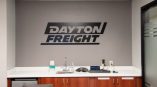 Black acrylic wall sign with bold letters above a countertop in Dayton, Ohio.