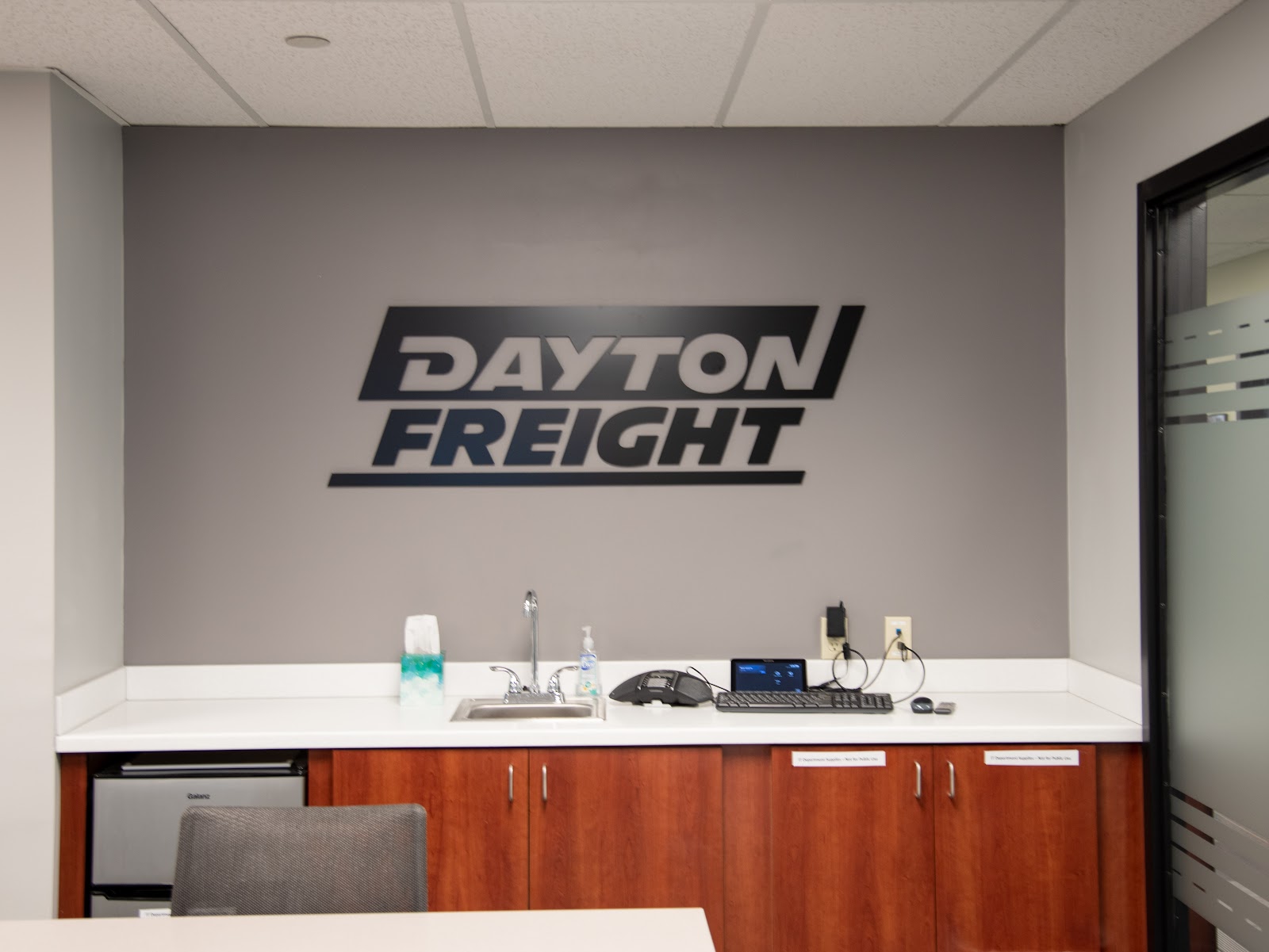 Black acrylic wall sign with bold letters above a countertop in Dayton, Ohio.
