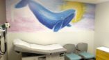 Whale wall art in hospital exam room