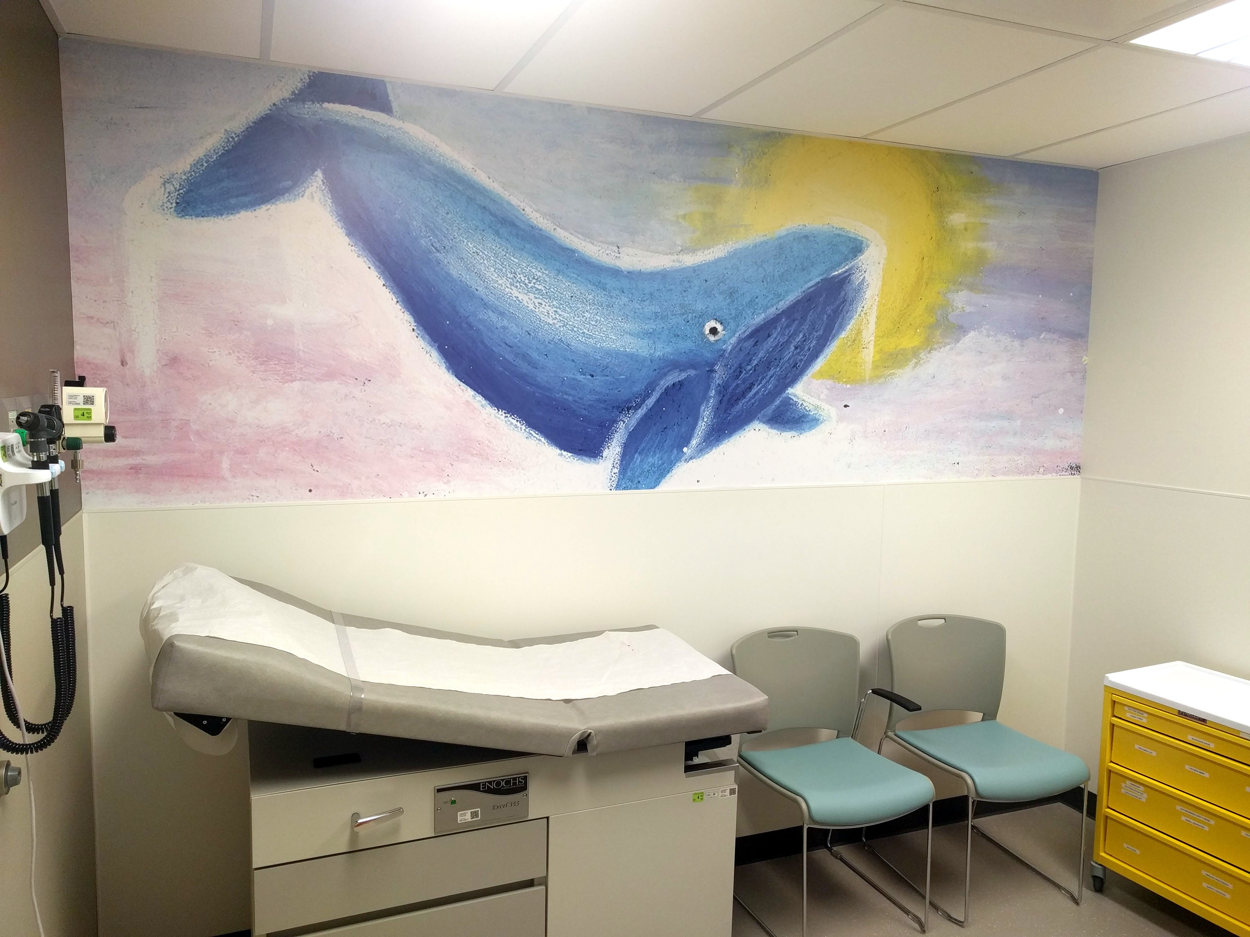 Whale wall art in hospital exam room