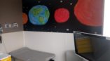 Planets wall mural in hospital exam room