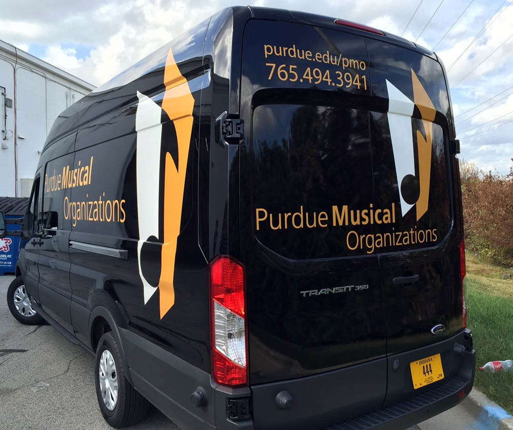 A passenger van for Purdue University with a custom vehicle wrap.