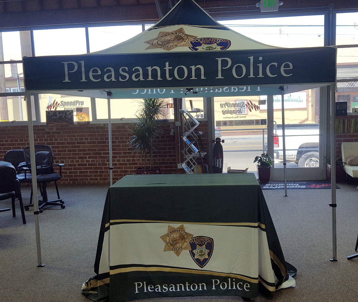 A custom printed table runner and tent made by Speed Pro Images for the Pleasanton Police department.