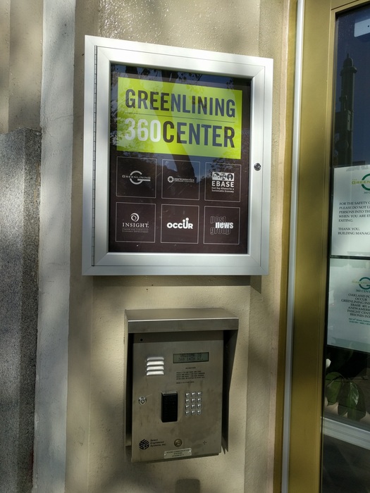 A custom directory sign above a security box for Greenlining 360 center.