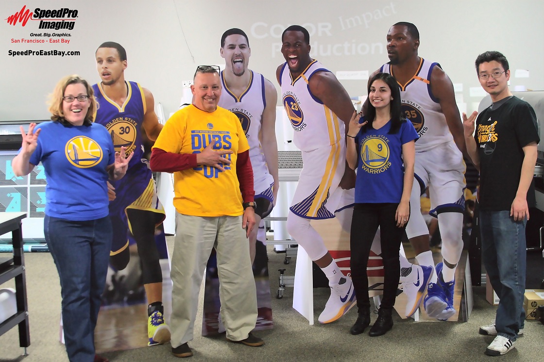 Life size cutouts of Golden State Warrior players Steph Curry, Klay Thompson, Draymond Green, and Kevin Durant.