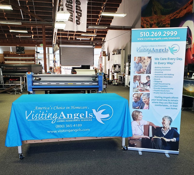 Visiting Angels table cover and standing banner