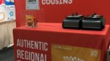 dozen cousins full tradeshow display with backdrop and table cover