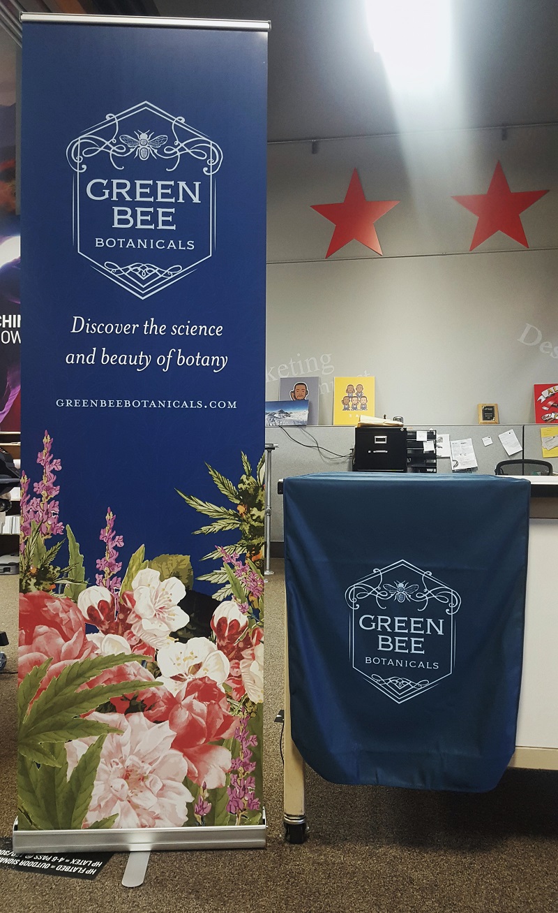 cannabis company green bee tradeshow set up with retractable banners and table cover