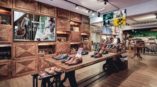 digital signage on screens featuring clothes products inside shoe store for men